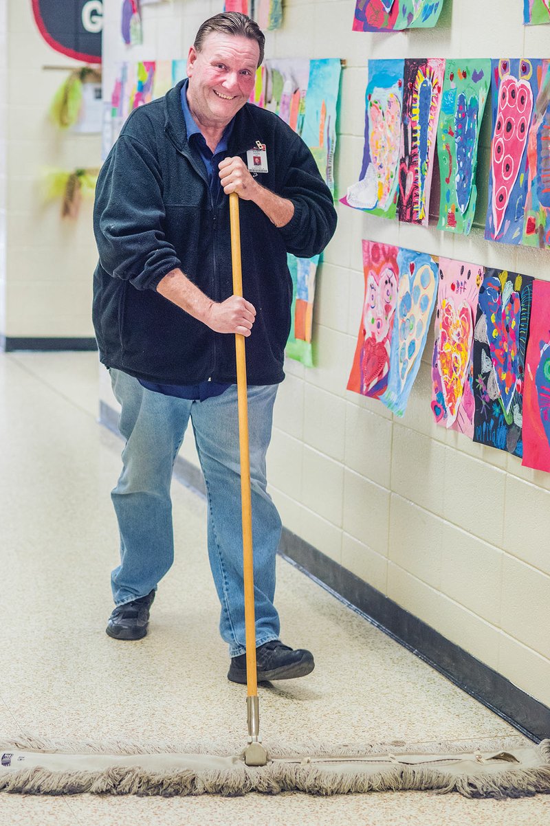 Vernon Strickland Jr., the custodian at Southside Elementary School in Cabot, sweeps one of the school’s hallways. Strickland said students sometimes help him keep the building clean.
