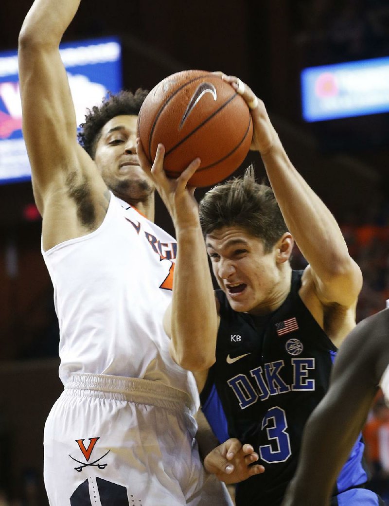 Duke’s Grayson Allen (right) drives to the basket against Virginia’s Isaiah Wilkins during Wednesday night’s game at Charlottesville, Va. 
