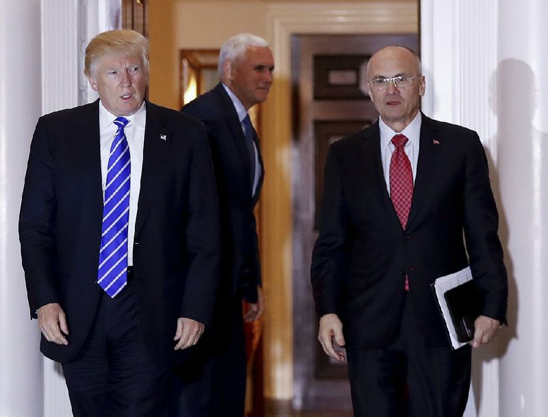  In this Nov. 19, 2016 file photo, then-President-elect Donald Trump walks Labor Secretary-designate Andy Puzder from Trump National Golf Club Bedminster clubhouse in Bedminster, N.J.