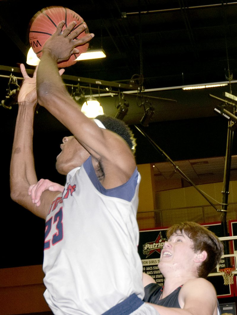 Photo by Rick Peck McDonald County&#x2019;s Cooper Reece grabs the arm of Providence&#x2019;s S.K. Shittu in an effort to keep the 6-10 center from scoring during the Mustangs&#x2019; 55-25 loss on Feb. 10 at Providence Academy in Rogers, Ark.