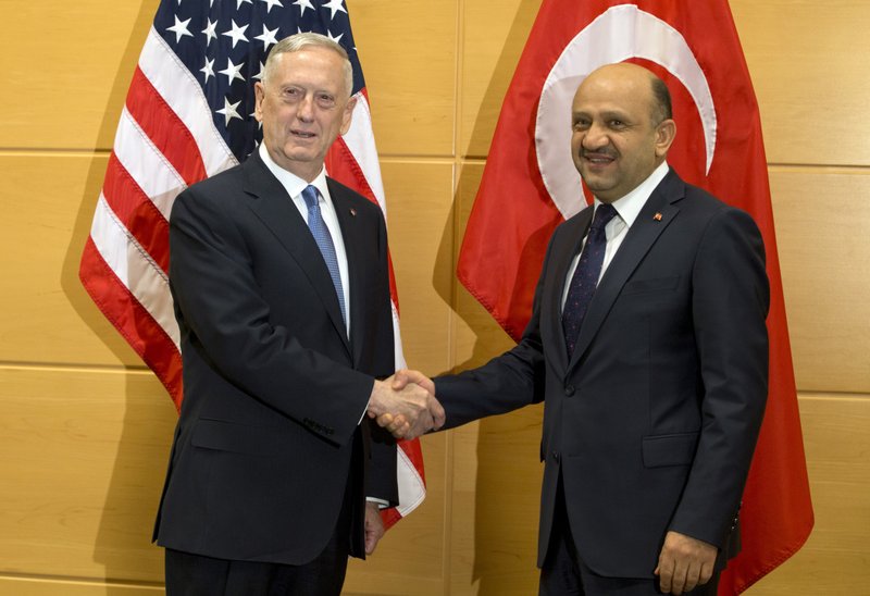 U.S. Secretary of Defense Jim Mattis, left, speaks with Turkish Defense Minister Fikri Isik during a meeting at NATO headquarters in Brussels on Wednesday, Feb. 15, 2017. For U.S. Defense Secretary Jim Mattis, the next few days will be a reassurance tour with a twist. He is expected to tell allies the U.S. is committed to NATO and is also hoping to secure bigger defense spending commitments. (AP Photo/Virginia Mayo, Pool)
