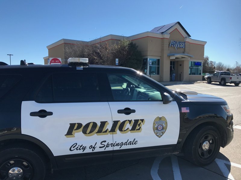 A Springdale police vehicle is seen at Arvest Bank on West Sunset Avenue in Springdale Thursday.