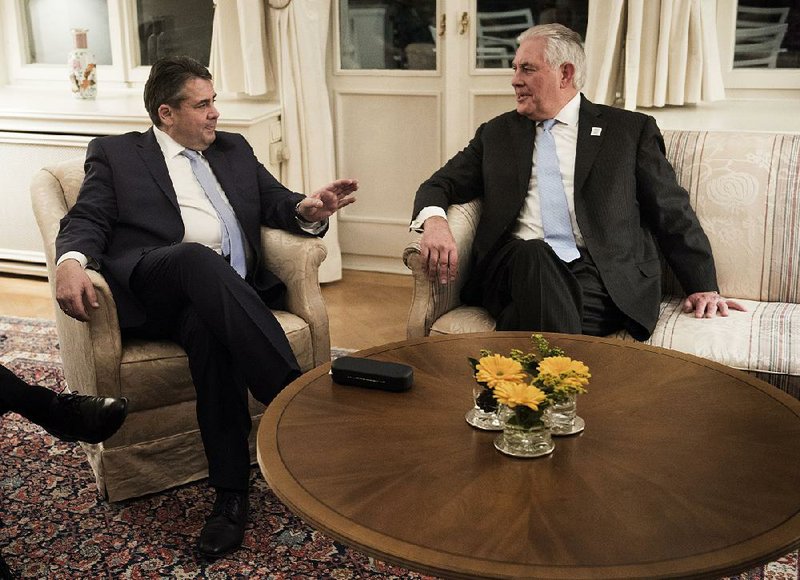 German Foreign Minister Sigmar Gabriel (left) and U.S. Secretary of State Rex Tillerson talk Thursday after a G-20 dinner at the Villa Hammerschmidt in Bonn, Germany.