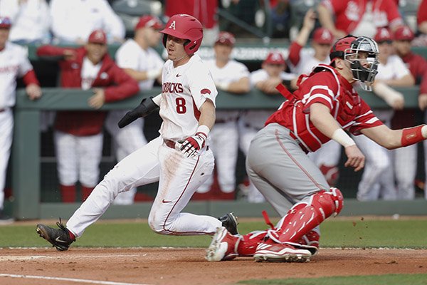 Arkansas outfielder Eric Cole scores the opening run of a game against Miami (Ohio) on Friday, Feb. 17, 2017, in Fayetteville. 