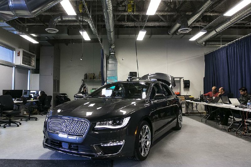 A self-driving Ford Lincoln sedan is parked at the Blackberry Ltd. QNX headquarters in Ottawa, Ontario, in December. Ford has set a goal of fully autonomous vehicles starting in 2021.