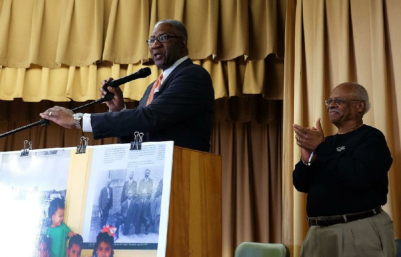 Pulaski County Circuit Judge Wendell Griffen speaks Friday in Elaine about the 1919 massacre and is applauded by Steven Bradley, a great-great-grandson of one of the defendants in the U.S. Supreme Court case Moore v. Dempsey that ordered criminal-justice protections for blacks. 