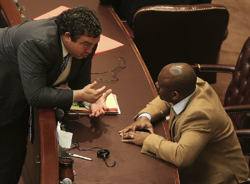 Rep. Michael John Gray (left), D-Augusta, talks with Rep. Fredrick Love, D-Little Rock, on Friday morning shortly before the House adjourned for the weekend.