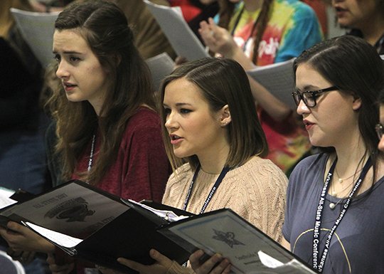 The Sentinel-Record/Richard Rasmussen CHORAL CELEBRATION: Lakeside High School senior Courtney DeVane, center, rehearses Friday in the All-State Mixed Choir with Russellville High School's Carolyn Etzel, left, and Brooklyn Howard, from Fort Smith Southside High School, in Hall A of the Hot Springs Convention Center. The state's top choral ensemble is scheduled to perform today at 1 p.m. in Hall A. Choral shows will begin at 11:30 a.m. with a 50th anniversary celebration by the Arkansas Choral Directors Association.