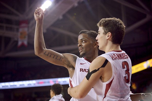 Daryl Macon and Dusty Hannahs of Arkansas celebrate as the Razorbacks close in on a victory over Ole Miss Saturday, Feb. 18, 2017, during the game at Bud Walton Arena in Fayetteville.