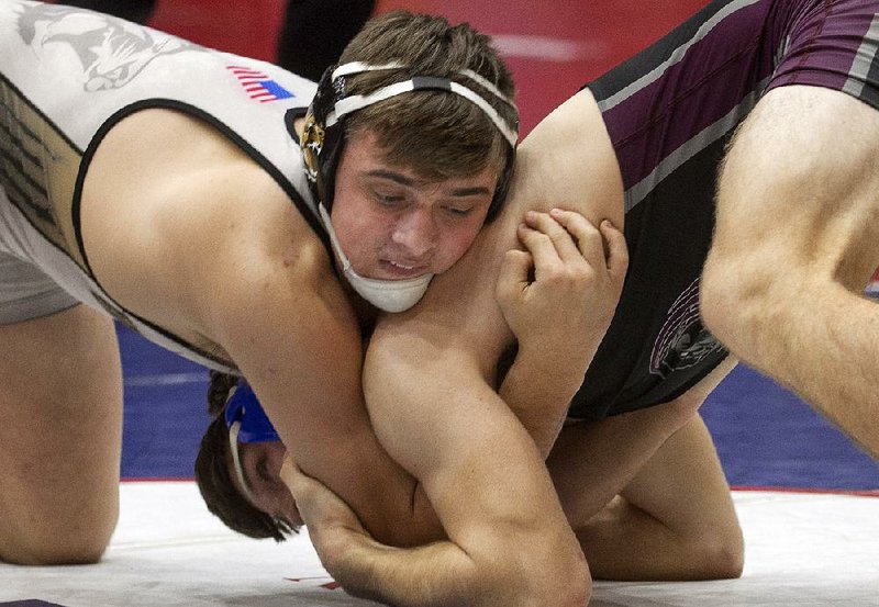 Bentonville’s Luke Brandon (left) the state’s winningest wrestler with 231 victories, scored a major decision over Benton’s William Brister in the Class 6A/7A 170-pound class Saturday. It was Brandon’s third state championship.