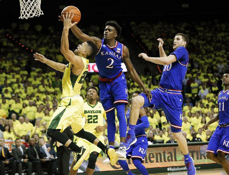 Kansas guard Lagerald Vick (2) leaps to block a shot by Baylor guard Manu Lecomte (left) during the second half of the No. 3 Jayhawks’ 67-65 victory over the No. 4 Bears on Saturday in Waco, Texas.