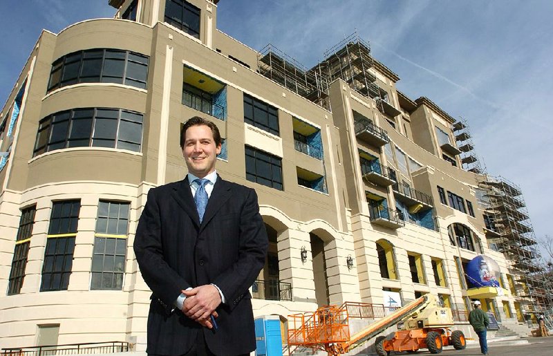 Brandon Barber stands in front of the Legacy Building in Fayetteville in 2006. The building was sold at a foreclosure auction in 2008. 