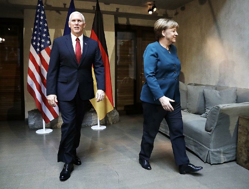 Vice President Mike Pence and German Chancellor Angela Merkel meet Saturday at the Munich Security Conference in Germany. Pence told allies the Trump administration will be “unwavering” in its support for NATO and “hold Russia accountable.” 