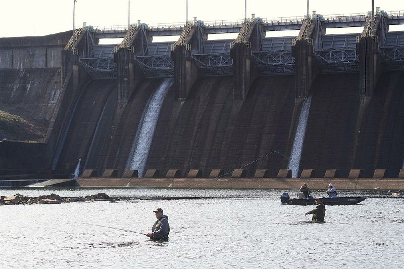 In this file photo anglers take advantage of low water and pleasant temperatures to fish for rainbow trout in the Lake Catherine headwaters below Carpenter Dam near Hot Springs.