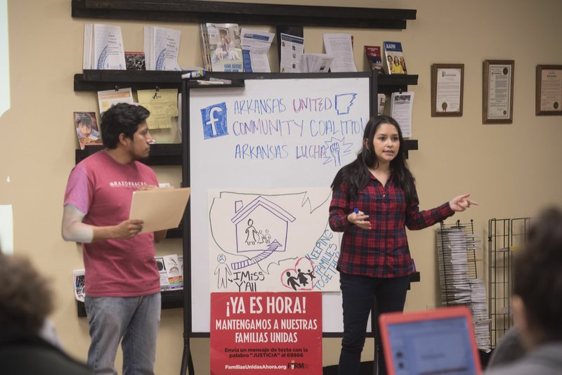 Fernando Garcia (left) and Diana Dominguez speak Feb. 10 to a group at Arkansas United Community Coalition office in Springdale as part of a Know-Your-Rights workshop for immigrants so they aren’t terrified to interact with Northwest Arkansas police. President Donald Trump signed an executive order allowing local law enforcement officials to do the duties of federal immigration officers when it comes to the investigation, apprehension or detention of residents living in the country without valid visas.