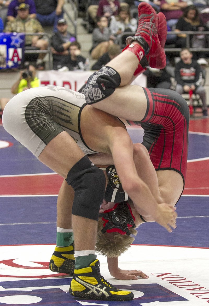 Arkansas Democrat-Gazette/BENJAMIN KRAIN Bentonville High&#8217;s Cash Jones (left) attempts to shake off Russellville&#8217;s Logan Sloss on Saturday in the championship match of the 145-pound class in the 6A-7A state high school wrestling tournament at the Jack Stephens Center in Little Rock.