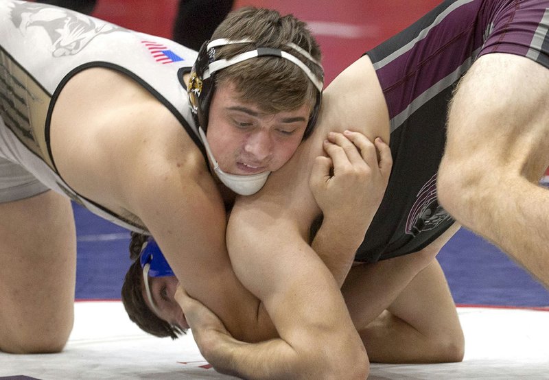 Bentonville High's Luke Brandon (left) won the 170-pound class title of the 6A-7A state wrestling championship tournament Saturday at the Jack Stephens Center in Little Rock. Brandon secured his third state title and has the most wins in Arkansas wrestling history.