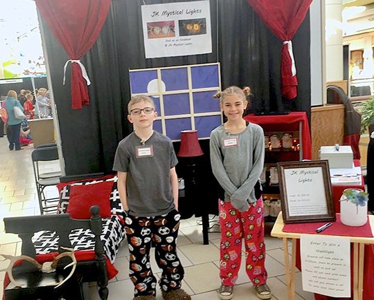 Submitted photo Cutter Morning Star Elementary School students Jacob Hardin, left, and Kyndal Fox earned two awards for their presentation in the 2017 Youth Entrepreneur Showcase for Arkansas Expo Day Jan. 27 on the third level of the Park Plaza mall in Little Rock. The top 25 teams were selected from 142 submissions from 25 schools in 15 counties were selected for the Expo Day in the 12th annual Y.E.S. for Arkansas. Their retail booth was set up for their product, "JK's Mystical Lights." They won third place for best retail booth and second place for best marketing piece.