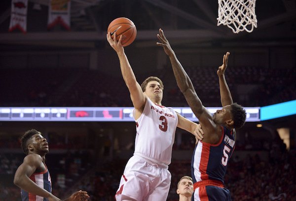 Dusty Hannahs (3) of Arkansas shoots over defense from Marcanvis Hymon (5) of Ole Miss in the first half Saturday, Feb. 18, 2017, during the game at Bud Walton Arena in Fayetteville.