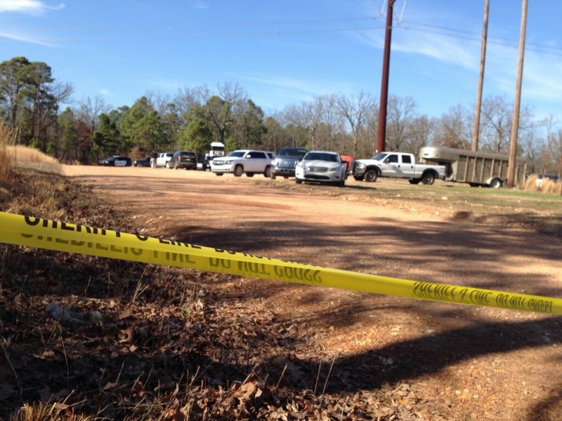 Police tape is seen Sunday near where authorities located a second set of human remains off Lookout Tower Road, near Siloam Springs.