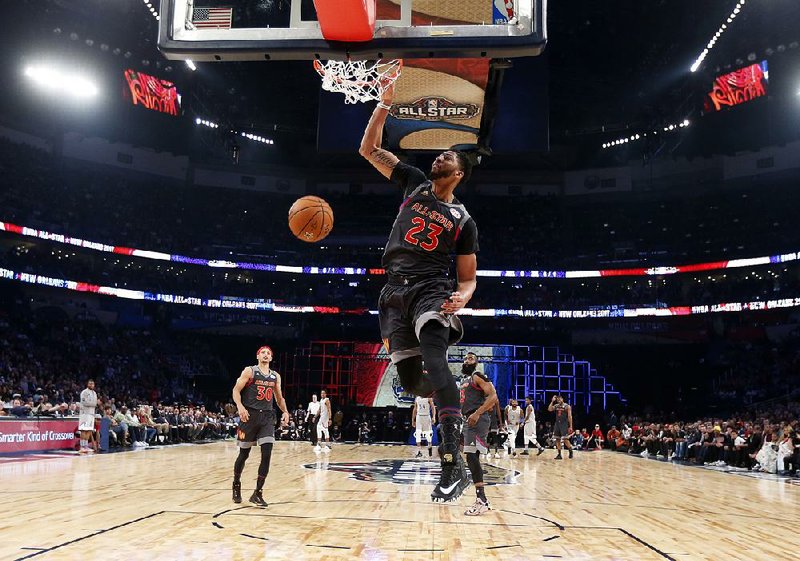Anthony Davis dunks for two of his record 52 points during the West’s 192-182 victory over the East in the NBA All-Star game Sunday in New Orleans. Davis hit 26 of his 39 shots and grabbed 10 rebounds to earn MVP honors. 