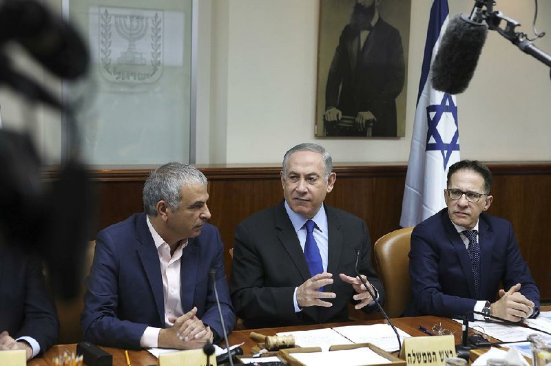 Israeli Prime Minister Benjamin Netanyahu (center) chairs the weekly Cabinet meeting Sunday in Jerusalem.