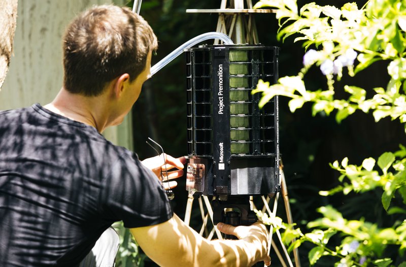 In this photo provided by Microsoft, Microsoft researcher Ethan Jackson sets up a trap for mosquitoes in Harris County, Texas in 2016. A new high-tech version trap is promising to catch the bloodsuckers while letting friendlier insects escape, and even record the exact weather conditions when different species emerge to bite. 