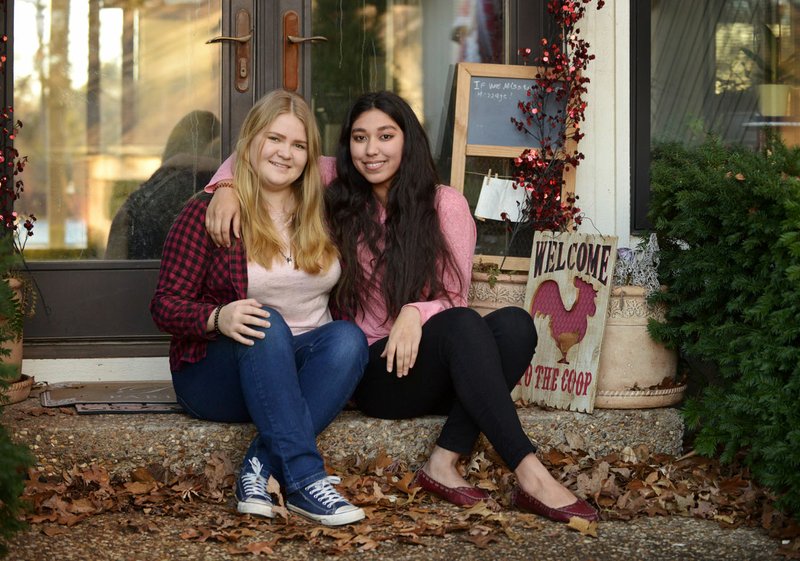 Rita Kadyrova (left), a Heritage High School senior from Kazakhstan, and Nigina Kholova, a Rogers High School senior from Tajikistan, pose for a photo Thursday at Charles and Daneen Parish’s home. The Parishes are Kholova’s host family in Rogers. The two are here on scholarships from the Future Leaders Exchange program of the U.S. State Department, which allows students from Europe and Eurasia to attend a year of high school in the U.S.