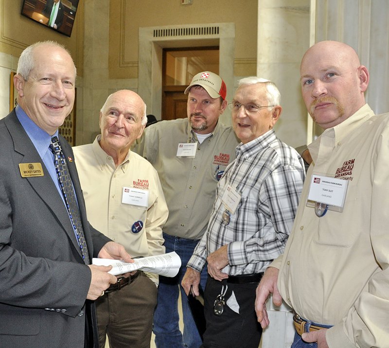 Submitted photo State Rep. Mickey Gates, left, visited with Garland County Farm Bureau members Tommy Sorrells, county president, of Royal, Keith Rucker of Pearcy, Ralph Pinkerton of Hot Springs and Tony Suit of Bonnerdale during Arkansas Farm Bureau's Farmers' Day held recently at the Capitol in Little Rock. Arkansas Farm Bureau sponsored the activity to raise awareness of legislative issues affecting Arkansas agriculture. Arkansas Farm Bureau is a nonprofit, private farm and rural advocacy organization of more than 190,000 Farm Bureau families throughout the state working to improve farm and rural life.