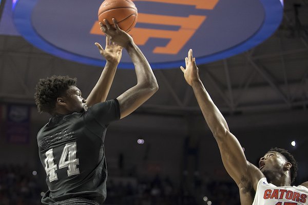 Texas A&M forward Robert Williams (44) shoots over the defense of Florida center John Egbunu (15) during the first half of an NCAA college basketball game in Gainesville, Fla., Saturday, Feb. 11, 2017. Florida won 71-62. (AP Photo/Ron Irby)