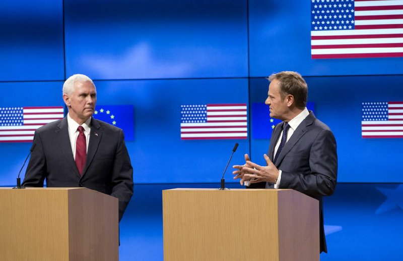 Vice President Mike Pence (left) and European Council President Donald Tusk address a news conference Monday at the EU Council building in Brussels.