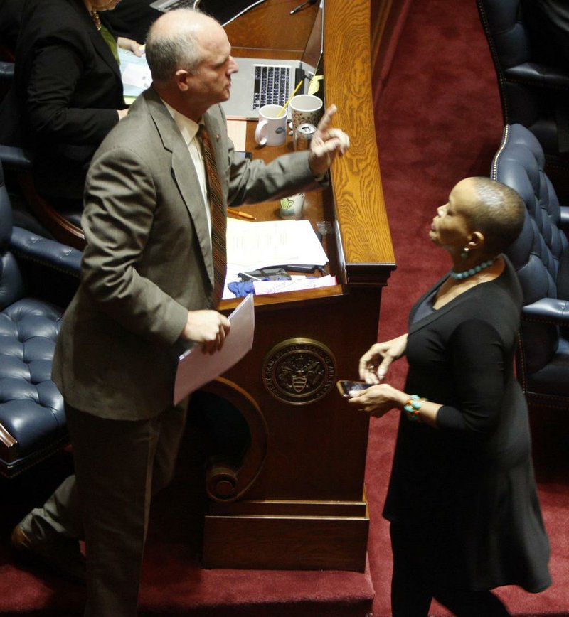 Sen. Jim Hendren, R-Sulphur Springs, signals he would like a certain status for his bill as Sen. Joyce Elliott, D-Little Rock, returns to her seat after speaking against the bill on the Senate floor Monday. 