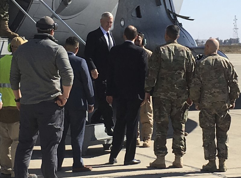 U.S. Secretary of Defense Jim Mattis, center, arrives at Baghdad International Airport, Iraq, on an unannounced trip Monday, Feb. 20, 2017. Mattis said Monday the United States does not intend to seize Iraqi oil, shifting away from an idea proposed by President Donald Trump that has rattled Iraq's leaders. 