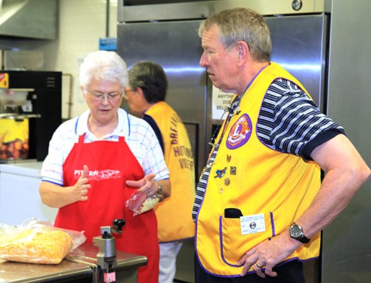 Submitted photo TOPPING TALLY: Hot Springs Village Breakfast Lions President Nancy Otto, left, and member Jim Podawiltz discuss the amount of cheese needed for the club's 40th annual Chili Day fundraiser, taking place from 11 a.m. to 2 p.m. and 4-7 p.m. March 11.