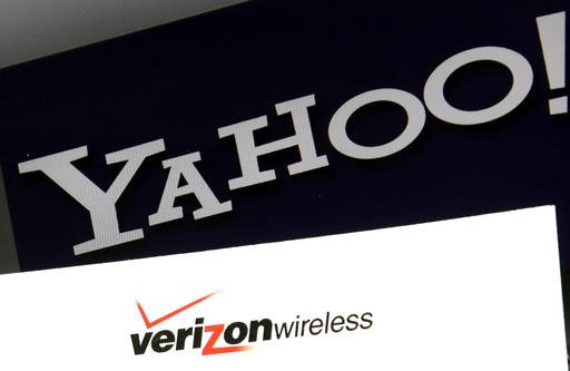 This Monday, July 25, 2016, file photo shows the Yahoo and Verizon logos on a laptop, in North Andover, Mass. 