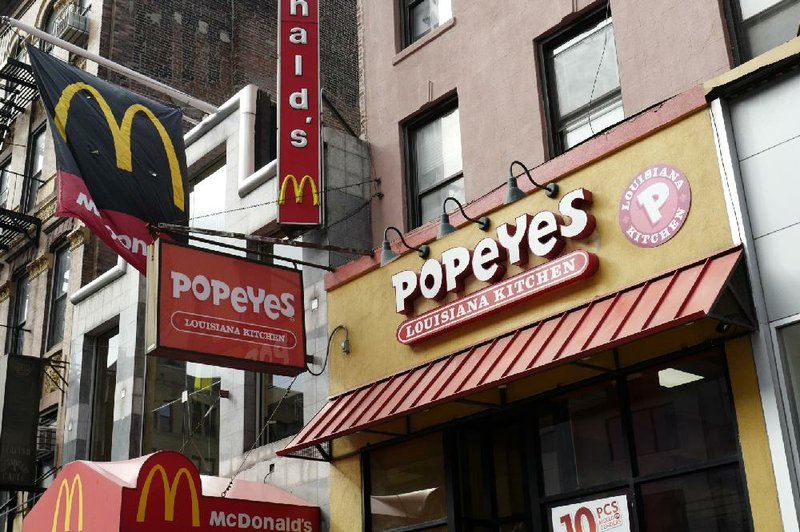 A Popeyes fast food restaurant stands next door to a McDonald’s in the Brooklyn borough of New York earlier this month. Restaurant Brands International, the parent company of Burger King and Tim Hortons, is buying Popeyes. 