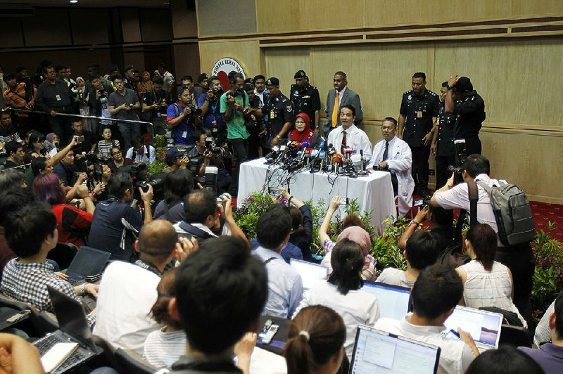 Noor Hisham Abdullah, (center) Malaysian health agency director, briefs reporters Tuesday in Kuala Lumpur on the autopsy of North Korean Kim Jong Nam, in which findings were inconclusive.