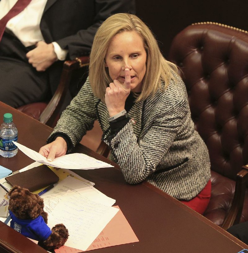 Rep. DeAnn Vaught watches on the House floor Tuesday as votes are tallied for her bill to allow a surcharge for natural-gas infrastructure expansion. The bill narrowly passed.