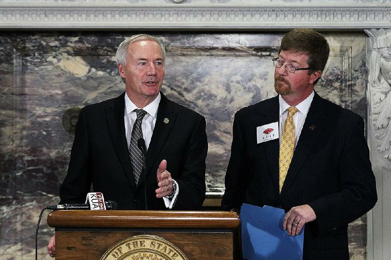 Govenor Asa Hutchinson, left, speaks as Commissioner of Education Johnny Key looks on during the R.I.S.E. (Reading Initiative for Student Excellence) Arkansas initiative press conference at the Capitol Thursday, January 26, 2017.