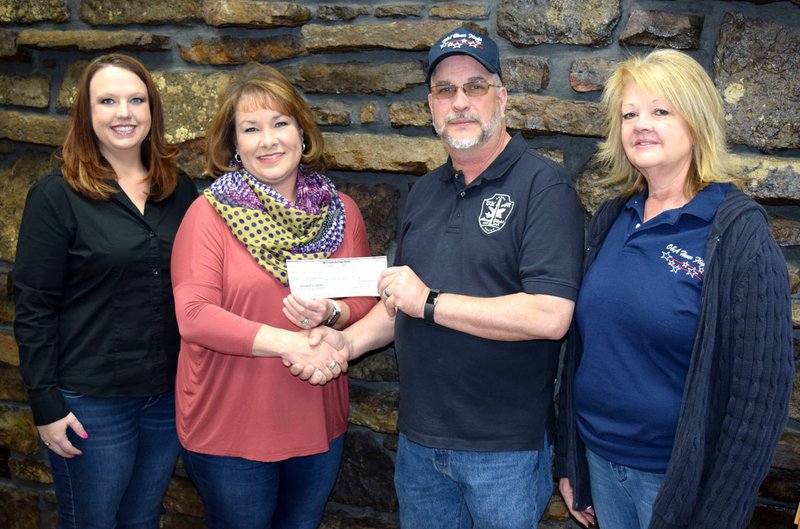 Photo by Mike Eckels The Oklahoma and Arkansas chapter of Honor Flight received a check from staff of Grand Savings Bank in Decatur Feb. 17. Those participating in the ceremony included: Meredith Renfroe (left), Carla Martinez, Rob Hopkins and Tami Hopkins. This donation was collected from all of Grand Savings Bank area branches.