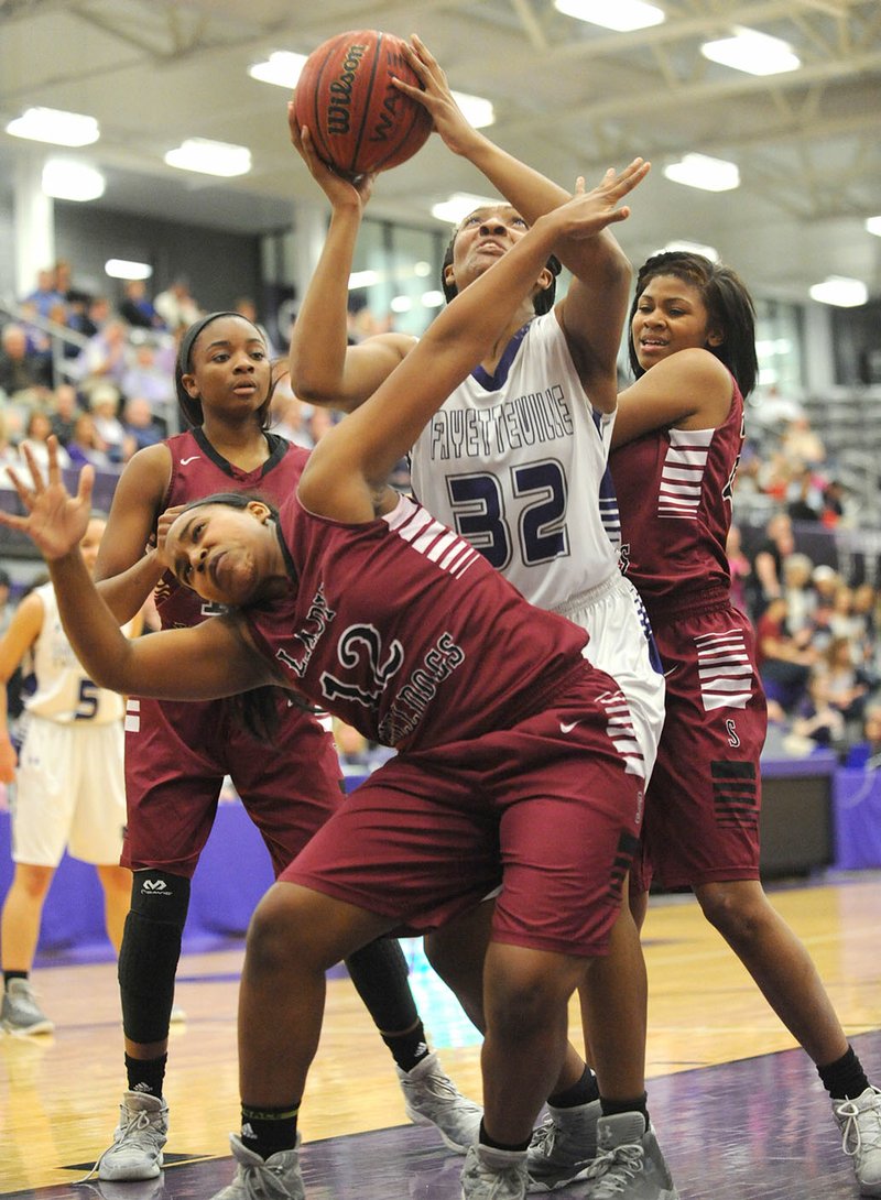 NWA Democrat-Gazette/ANDY SHUPE Fayetteville forward Jasmine Franklin (32) tries to score over Springdale High guard Destiny Jackson (12) on Tuesday at Bulldog Arena in Fayetteville. Visit nwadg.com/photos for more photographs from the game.