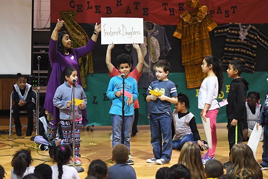 The Sentinel-Record/Mara Kuhn UNHIDDEN FIGURES: Langston Aerospace and Environmental Studies Magnet School teacher Clarice Anderson, left, directs second-grade students during an activity Tuesday for Black History Month. Students read clues about significant figures in black history and revealed the answers afterward.