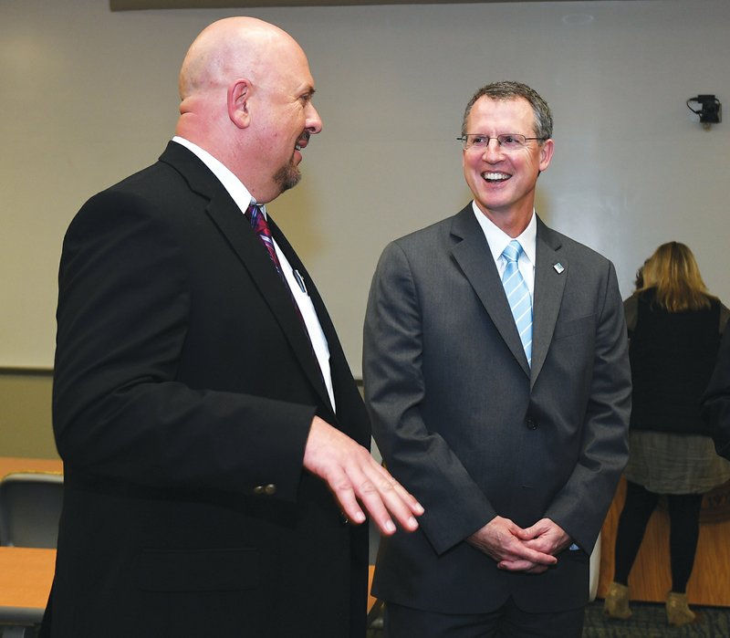 The Sentinel-Record/Mara Kuhn SATELLITE LEGACY: Lakeside Superintendent Shawn Cook, left, and National Park College President John Hogan met with representatives from both institutions Tuesday evening during the Lakeside School Board meeting to announce Lakeside High School has been cleared as an official satellite campus for the college. The Lakeside Legacy Program was announced in January 2015, allowing Lakeside students to earn up to 66 hours of college credit by the time they graduate.