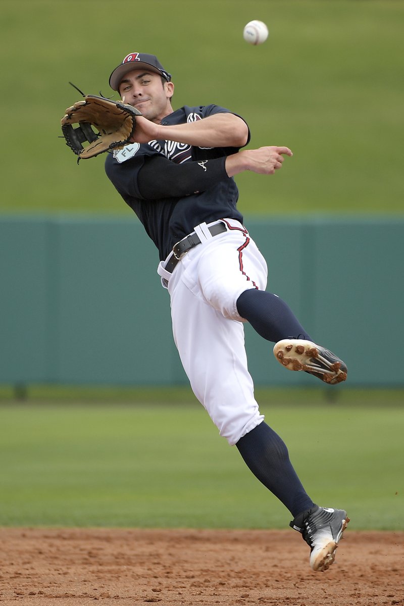 The Associated Press FLING TO FIRST: Atlanta Braves shortstop Chase D'Arnaud throws to first base after fielding a grounder during the first full-squad spring training workout in Lake Buena Vista, Fla., Saturday.