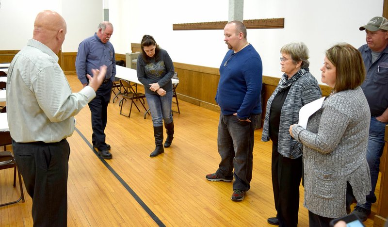 Decatur Mayor Bob Tharp (left) showed members of the Decatur City Council and other department heads the floor in the community room on Feb. 13. The council voted to renovate the floors, restrooms and kitchen in the City Hall facility.