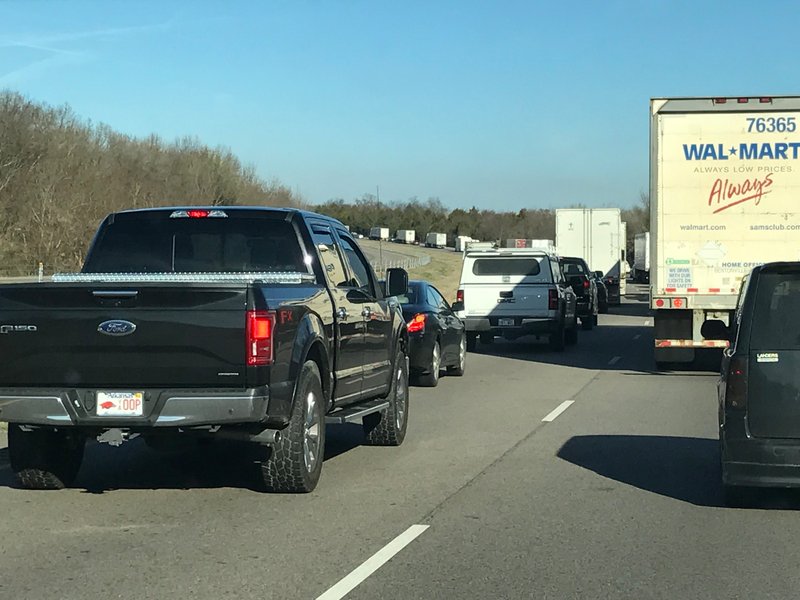 Eastbound traffic stands still about 4 miles east of I-49 on I-40 as officials work to clear a tractor-trailer hauling 40,000 pounds of ammunition after it caught fire in Franklin County Wednesday.