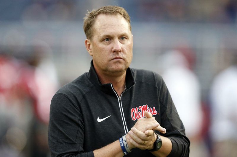 In this Oct. 24, 2015, file photo, Mississippi football coach Hugh Freeze watches his team warmup before an NCAA college football game against Texas A&M in Oxford, Miss. 