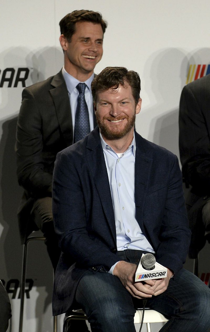 In this Jan. 23, 2017, file photo, Monster Energy NASCAR Cup Series driver Dale Earnhardt Jr., foreground, attends a news conference for an announcement of NASCAR's approach to modernizing its series with a new format, in Charlotte, N.C. 