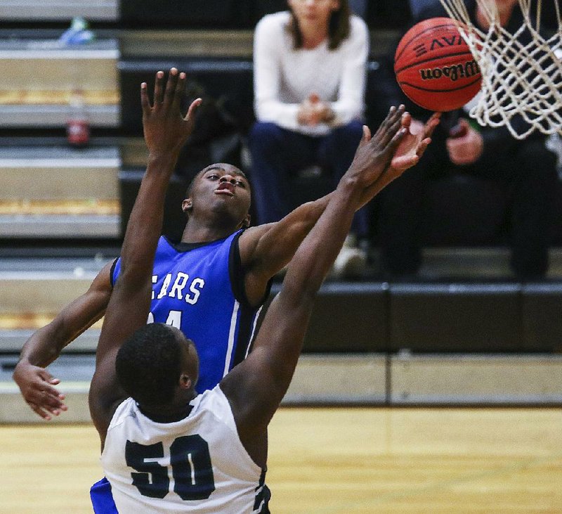 J.D. Smith of Sylvan Hills puts up a shot in front of Little Rock Christian’s Kalin Bennett (50) during the Bears’ 56-50 victory over the Warriors on Wednesday at the 5A-Central Tournament in Maumelle.