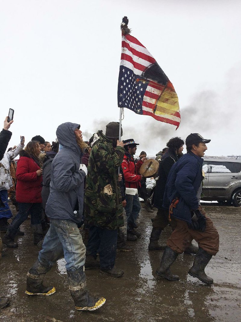 People peacefully leave the Dakota Access pipeline main protest camp Wednesday near Cannon Ball, N.D., as authorities prepare to shut it down in advance of the spring flooding season.